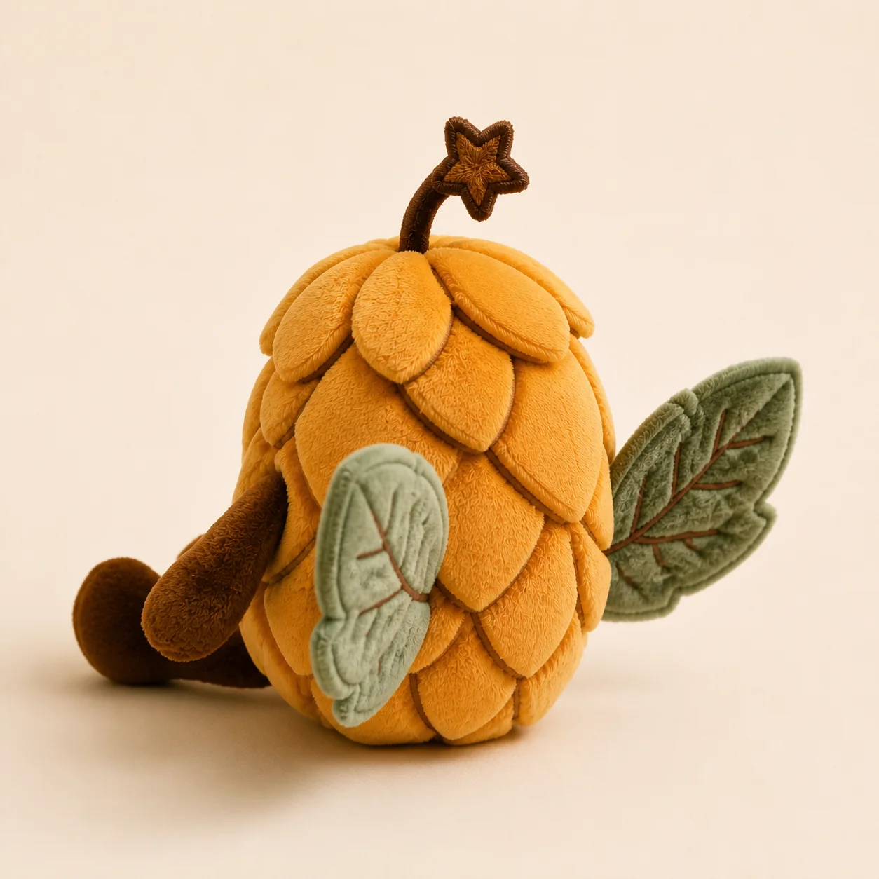 Hopper viewed from behind at three quarters, showing layered plush leaves and the stitched wing attachments